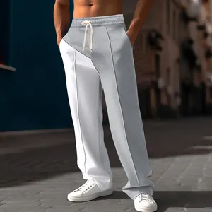 Low-angle view of men's two-tone grey and white oversized straight-leg casual pants