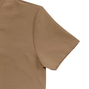 Detailed view of the shoulder seam and fabric texture on a men's brown linen shirt.
