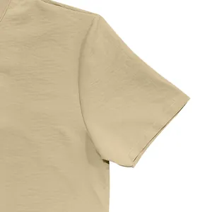 Close-up of the linen fabric texture and short sleeve seam on a khaki men's shirt.