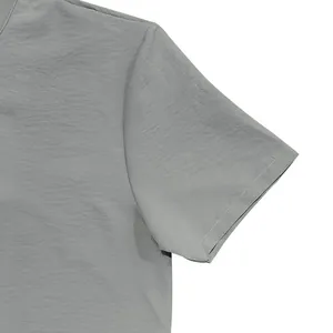 Close-up detail of the grey textured fabric and sleeve seam of a men's summer shirt