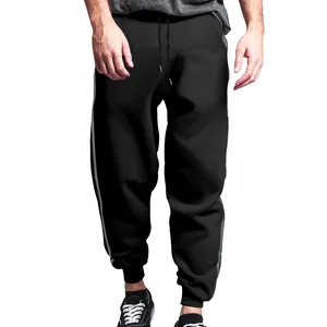 Close-up view of men's black sports joggers featuring double side stripes and drawstring