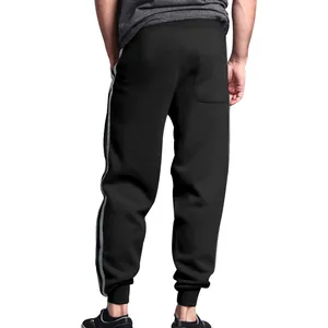 Detailed back view of men's black joggers with grey double stripes and cuffed ankles.