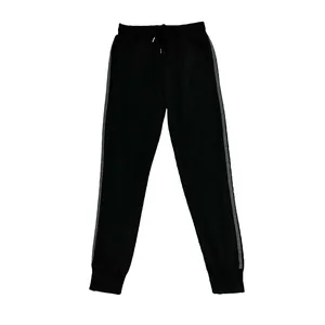 Detailed view of black men's jogger sweatpants with grey side stripes and elastic cuffs