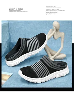 Detail of breathable black fly-woven slip-on mule sneakers with white thick sole