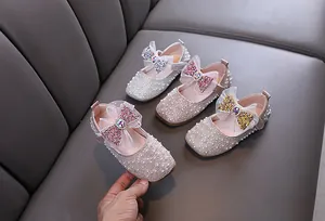 Detailed view of girls' pearl princess shoes with sequined bows in multiple colors