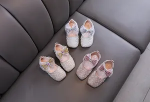 Detailed view of girls' pearl princess shoes with sparkling bows in multiple colors