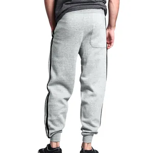 Back view of comfortable men's gray sweatpants featuring black double side stripes and joggers cuffs
