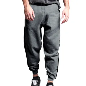 Close-up detail of grey men's joggers featuring black side stripes and drawstring