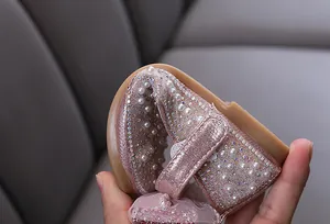 Detailed view of flexible pink sparkling princess shoes with pearl and rhinestone embellishments