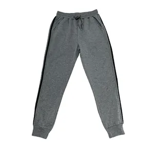 Detailed view of grey men's jogger sweatpants featuring athletic black side stripes