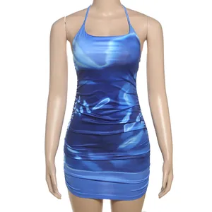 A detailed view showing the blue tie-dye ruched bodycon dress with a halter neck.