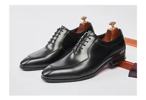 Detailed side view of classic black leather Oxford shoes for men's formal attire