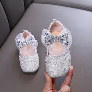 Sparkling white princess shoes for girls featuring pearls and a rhinestone mesh bow detail