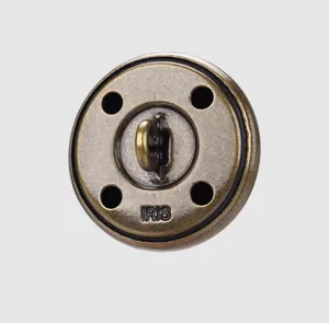 Detailed macro shot of a vintage brass metal button with embossed IRIS brand name
