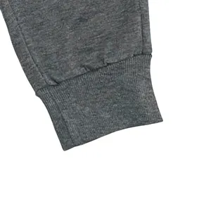 Detailed macro shot showing the elastic ribbed cuff of grey heathered mens joggers pants