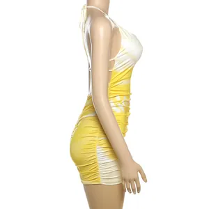 Side view of yellow and white tie-dye halter backless bodycon dress with pleats