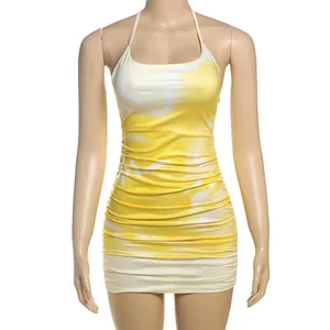 Close-up detail of yellow tie-dye halter neck ruched bodycon mini dress for women