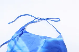 Detail view of blue gradient halter neck dress showing elegant satin tie-up straps