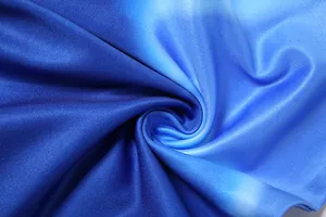 Macro view of premium blue gradient ribbed fabric texture for stylish summer dress