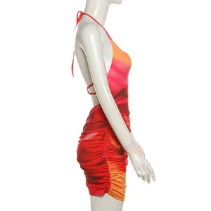 Side view detail of halter neck sunset gradient bodycon mini dress with ruching