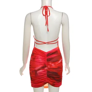 Back view of a ruched halter neck mini dress with vibrant tie-dye print.