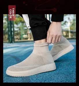 Close-up detail of beige breathable fly-knit casual sneaker worn on an outdoor court surface