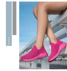 Detailed view of magenta fly-knit slip-on sock shoes with textured rubber soles