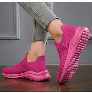 Detailed view of pink fly-knit slip-on sneakers with chunky soles