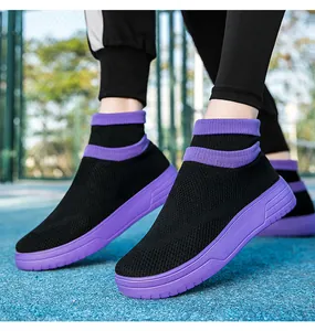 Detailed view of breathable black fly-knit sock sneakers featuring a thick purple rubber sole