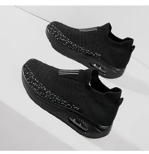 Side view detail of black breathable knit sock sneakers with air cushion platform