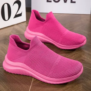Vibrant pink fly-knit sock sneakers for women, breathable slip-on mesh sports shoes.