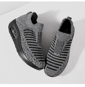 Top-down view of women's breathable grey flying-knit sneakers with thick air cushion soles.