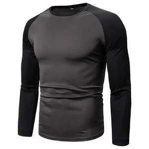 Close-up of a men's grey and black color-block long-sleeved T-shirt with a crew neck.