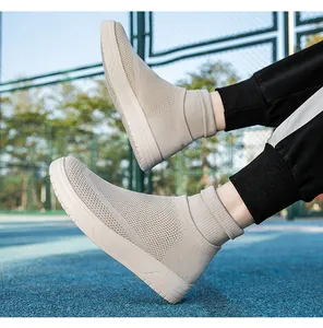 Detail view of breathable beige knit mid-top sneakers for men and women on court