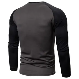Back view of a men's raglan long sleeve t-shirt in grey and black color block