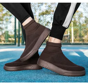 Close-up of brown breathable fly-knit sock sneakers worn on a blue athletic court