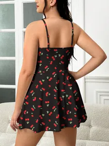 Detailed back view of a plus size black camisole dress featuring a vibrant red cherry print