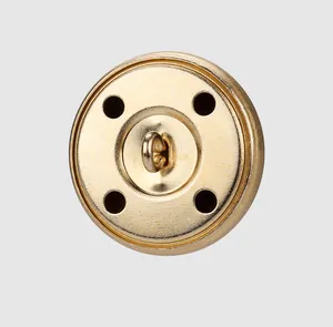 Detailed close-up of a high-quality golden brass shank button for luxury garment design.