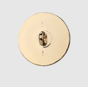 Detailed back view of a polished gold metal shank button for high-end women's apparel