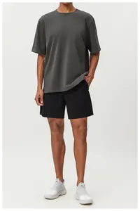 Full view of men's dark grey cotton t-shirt and black shorts on a model