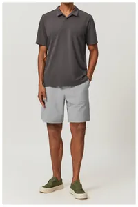 Close-up of a men's dark grey breathable cotton polo shirt and light grey shorts