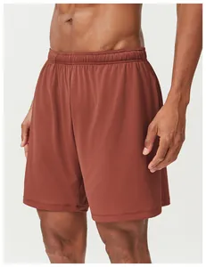 Detailed view of men's breathable quick-dry mesh athletic shorts in terracotta red