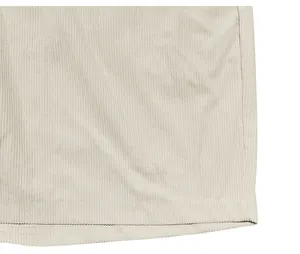 Macro detail showing the texture of beige corduroy fabric for men's retro cargo shorts.