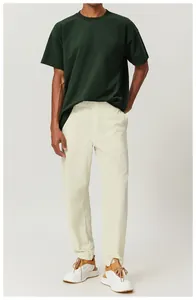 Hombre con una camiseta de algodón de corte grande verde oscuro para paseos por la ciudad