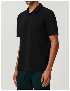 Side detail view of a loose-fit breathable black cotton sports polo shirt for golf