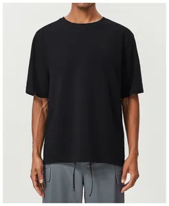 Close-up view of a high-quality black cotton T-shirt fabric on a male model in a studio