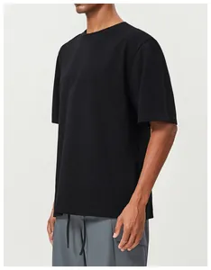 Detailed side view of a black cotton t-shirt for men, showing fabric and loose fit.