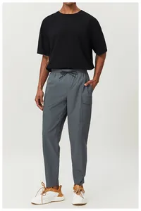 Men's breathable cotton black sports T-shirt paired with grey casual outdoor pants.