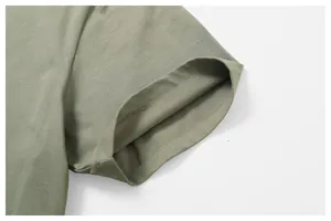 Detailed macro view showing the high-quality stitching on an olive cotton T-shirt sleeve.
