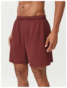 Detailed view of breathable mesh fabric on men's maroon quick-dry sports shorts